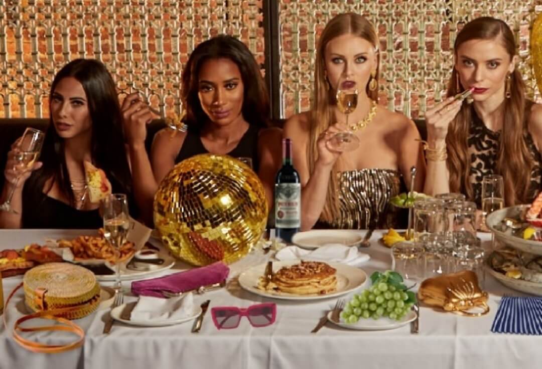 girls enjoying drinks and food at a party